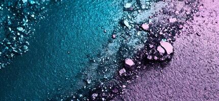 Turquoise and violet eyeshadow background displays diverse textures with crushed, sparkling, and grainy elements photo