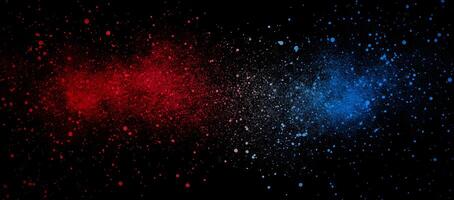 Vivid red and blue paint splatters create a dynamic contrast on a black canvas photo