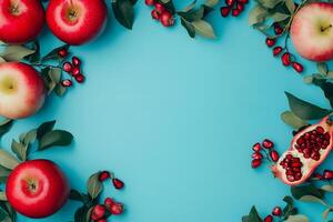 Vivid still life features red apples, pomegranates, and greenery against a light blue background photo