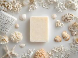 White soap bar is placed amidst shells and coral for serene, spalike feel photo