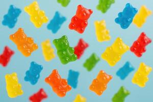 Brightly Colored Gummy Bears Floating Against Soft Blue Background Creating Whimsical Playful Atmosphere Candy Themed photo