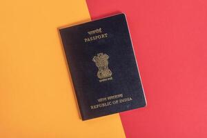 Close up of an Indian passport against a vibrant red and orange background. photo