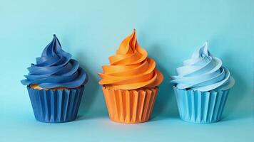 Three Cupcakes With Colorful Frosting Against Blue photo