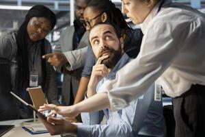 Data center coworkers doing brainstorming, working together to verify neural network parameters. Server hub staff members talking, inspecting configurations to ensure optimal performance photo