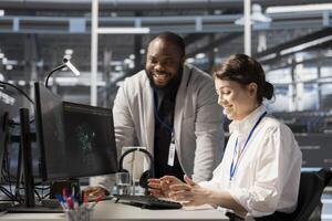 Delighted data center team leader reacting with satisfaction after seeing improved system efficiency metrics. Manager satisfied with enhanced equipment performance after finishing update photo