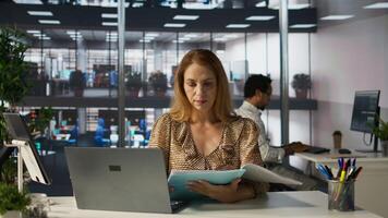 Executive assistant at a multinational company work on next big business project. Professional worker uses tech tools to manage operations and ensure a successful enterprise outcome. Camera B. photo