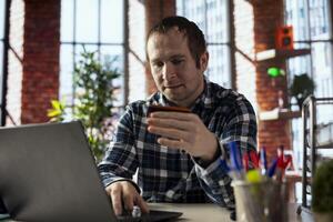 Man doing internet shopping, typing credit card information on laptop, placing items in cart, advancing through checkout steps. Person doing online transactions, adding payment method on website photo