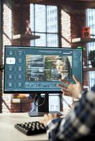 Content creator in home office getting help from generative artificial intelligence GPT generating videos. Close up of AI virtual assistant producing clips from prompts on computer screen photo