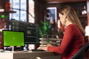Focused person engaging with AI assistant on pc next to chroma key, using the chatbot for automation and data driven algorithms to provide instant solutions. Connectivity and online tasks. photo