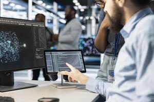 Close up of computer scientists in data center office integrating AI driven automation tools. Server farm employees cooperating, using artificial intelligence deep learning models photo