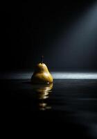 A pear floating in water with a spotlight shining on it photo