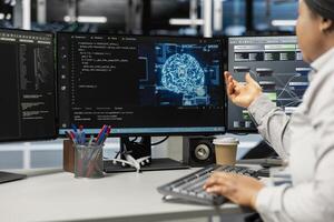 Server room expert using artificial intelligence technology to reduce downtime. African american professional at work designs and implements AI driven solutions for data center gear photo