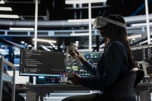 Computer scientist in data center using VR headset run artificial intelligence and machine learning processes. Server room IT expert using AI tools and virtual reality technology photo