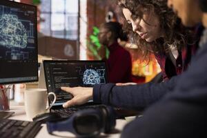 Coworkers doing brainstorming in AI tech agency providing software development services. Close up of startup office colleagues cooperating, using artificial intelligence to streamline coding process photo