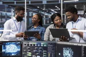 Teamworking server room colleagues use artificial intelligence to perform computing tasks. Data center engineering team doing brainstorming, working together, using AI for machine learning workloads photo