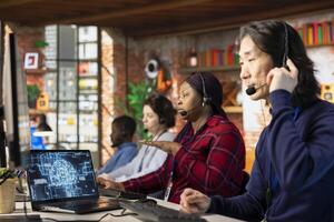 Team of multiethnic call center workers using AI chatbot to reply to common customer queries. Multiracial customer service coworkers generate automated responses to clients using AI photo