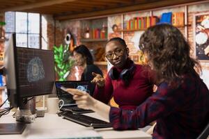 AI startup office colleagues cooperating, designing and implementing algorithms enabling machine learning. Teamworking artificial intelligence tech venture employees collaborating to fix code bugs photo
