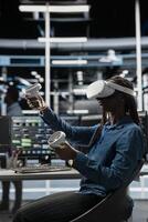 Server room technician using virtual reality tech and artificial intelligence to reduce downtime. Admin using VR simulation headset to design and implement AI driven solutions for data center equipment photo