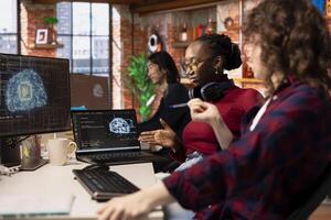 Teamworking startup technicians cooperating to do rapid technological advancement in AI industry. Silicon Valley company colleagues leveraging deep learning tech in workspace to gain competitive edge photo