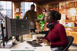Software developer solving tasks with AI LLM chatbot answering prompts using predictive technology. Startup employee using computer to interact with generative large language model app photo