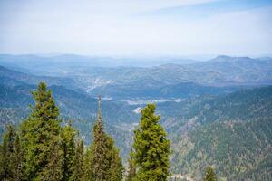 Panoramic view from Mount Kokuya at Teletskoye Ski Resort. Spring landscape with snow and mountains in Altai, Russia. High quality photo