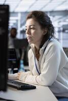 System administrator in server hub implementing power management solutions to reduce energy consumption. Employee integrating new technologies and systems in data center facility photo