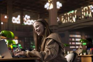 Confident student gathers information and citations from reliable sources via university library massive database, working on bachelor degree paper. Intelligent girl working for a certificate. photo