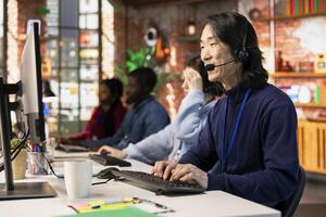 Call center agent handling customer inquiries, complaints and support requests in office. Customer service representative assisting customers with issues related to products or services photo