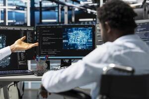 Server room facility worker using artificial intelligence to perform demanding computing tasks. Computer scientist in data center uses AI technology for machine learning workloads photo