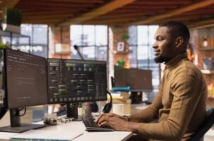 Upbeat software engineer coding advanced AI algorithm and machine learning models enhancing automation. Jolly IT worker using computer in innovative Silicon Valley workplace photo
