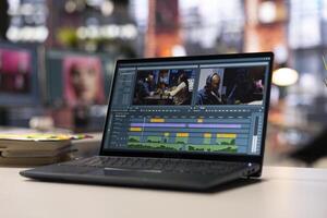 Modern workspace with a editing software on laptop for creative people, showing an empty desk with pc running advanced montage making techniques. shoot post production. photo