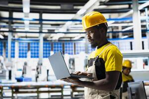 Photovoltaics factory engineer using laptop to do performance testing of solar panel production line. Technician improving sustainable solar energy configurations for cost reduction. photo
