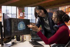 CTO manager in multiethnic startup office helps technician coding advanced AI algorithm and machine learning models. Team leader overseeing work done by employee in Silicon Valley workplace photo