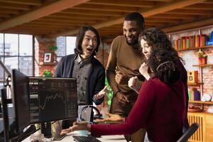 Diverse startup team congratulate each other after successfully launching on stock market, generating high investment returns. Multiethnic tech venture company securing funding for pioneering software photo