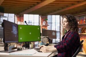 System administrator using isolated screen PC working with artificial intelligence technology in tech startup. Mockup computer display used by IT expert developing AI systems in tech startup photo