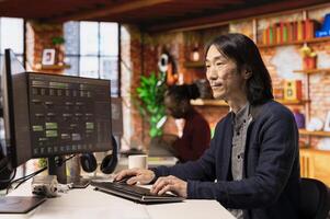 Senior technician working in innovative startup office using programming languages to build application. Experienced software development agency IT CTO manager optimizing code on computer photo