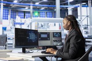 Engineer coding in solar panel plant, using artificial intelligence to automate equipment processes. Photovoltaics factory programmer writing scripts to optimize robotic operations using AI tech photo
