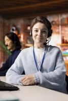 Portrait of smiling call center agent talking with customer, adhering to company provided communication guidelines. Happy customer support worker following call script during chat with client photo