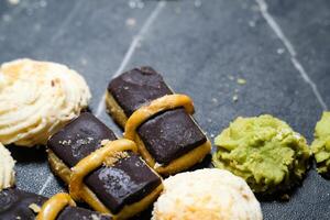 4 kinds of cookies with copy space. Top shot Chocolate bar, sago cheese and green tea cookies arranged in a row. Tasty and delicious pastry. . Snacks and sweet food. Food photography themes photo