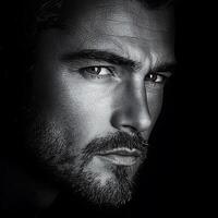 A black and white photo of a handsome man with a beard