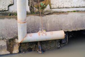 L-shaped iron pipe for drainage above the gutter. Waste drainage from a factory built in the area outside the factory area. Hazardous waste management. Health, Safety and Environment photo