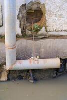 L-shaped iron pipe for drainage above the gutter. Waste drainage from a factory built in the area outside the factory area. Hazardous waste management. Health, Safety and Environment. Copy space photo
