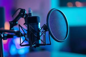 A microphone is sitting on a stand in front of a microphone photo