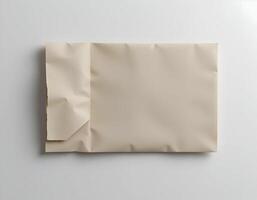 Tan Paper Sheet with Torn Edge Lying Flat on White Surface photo