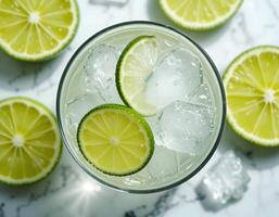 Refreshing Lime Drink with Ice Cubes on Marble Surface photo