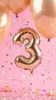 shiny number balloon shaped like the against three floats gold a pink background. Colorful balloons and confetti surround it, creating a festive atmosphere photo