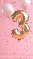 shiny gold balloon shaped like the number three a against floats pink background. Colorful balloons and confetti surround it, creating a festive atmosphere photo