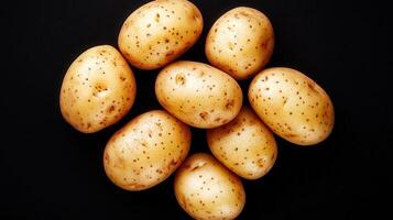 Boiled potatoes arranged a creating heart shape on a black background, in a simple yet visually appealing image photo
