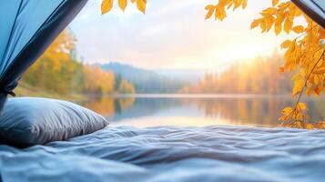 Warm sunlight illuminates a the tent interior with a blanket and pillows, creating a peaceful camping cozy in scene autumn woods photo