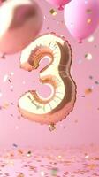 shiny confetti balloon shaped like the number three floats against a pink background. Colorful balloons and gold surround it, creating a festive atmosphere photo